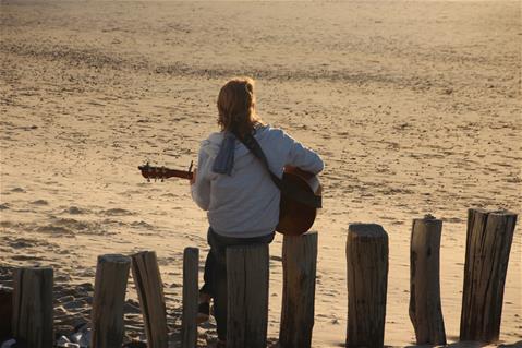 Guitar player on beach